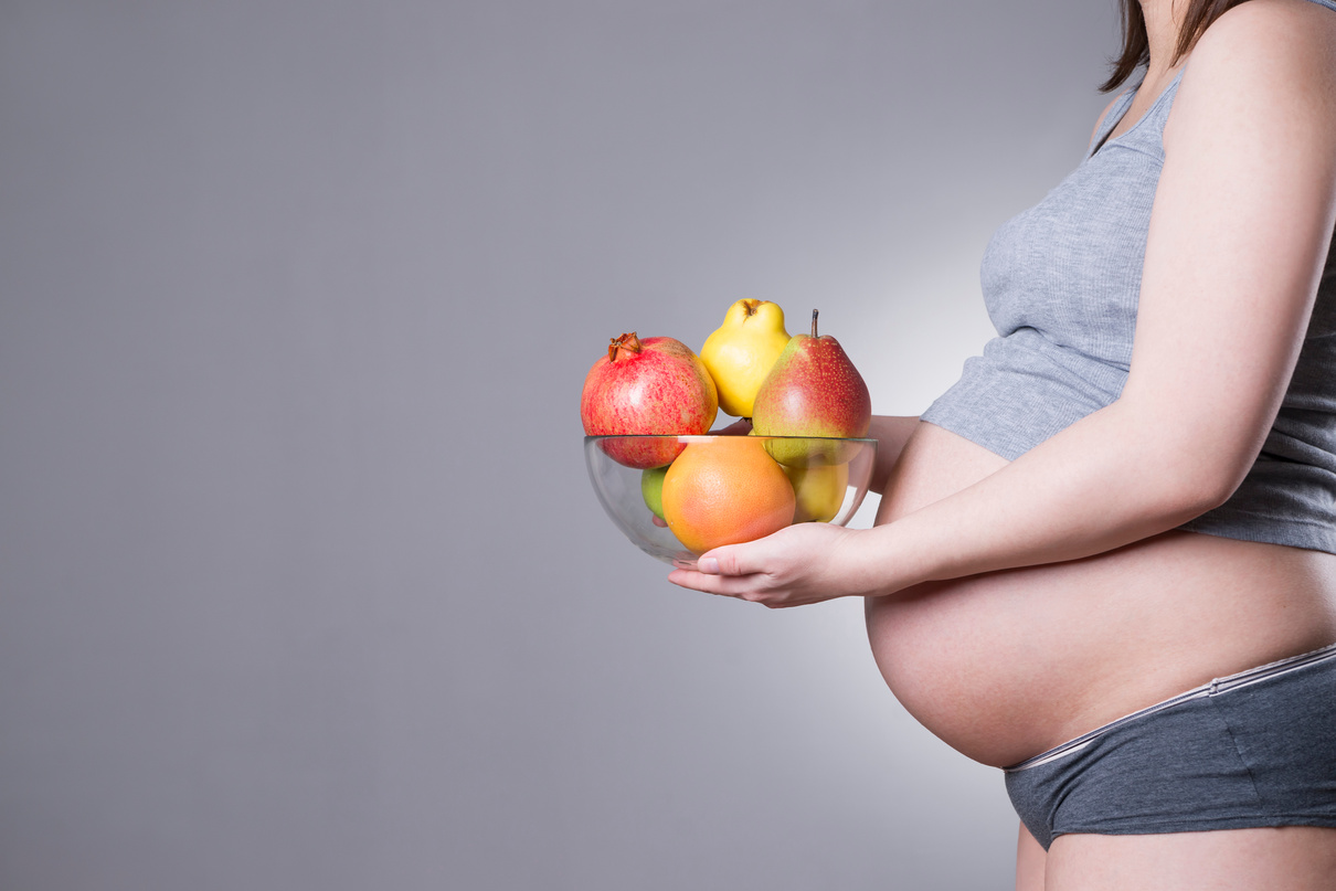 Pregnancy and nutrition - pregnant woman with fruit